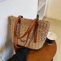 Structured luxe handbag densely hand woven in straw in beige or brown