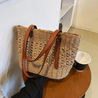 Structured luxe handbag densely hand woven in straw in beige or brown