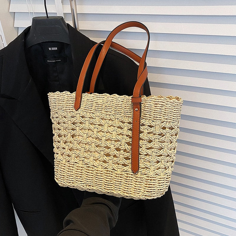 Structured luxe handbag densely hand woven in straw in beige or brown