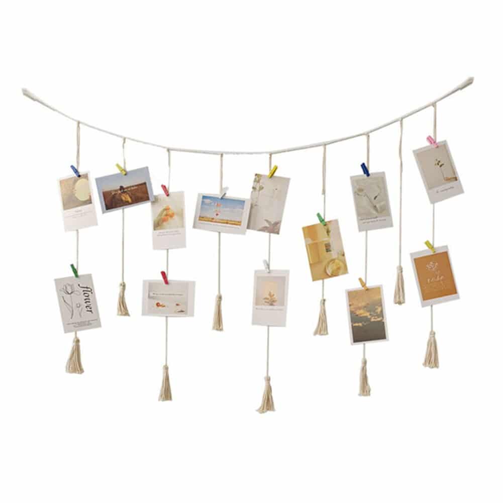 Macrame photo display with clips holding photos and postcards