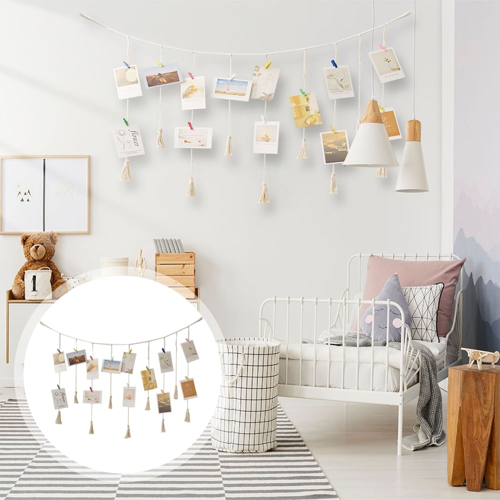 Macrame photo display with clips holding photos and postcards