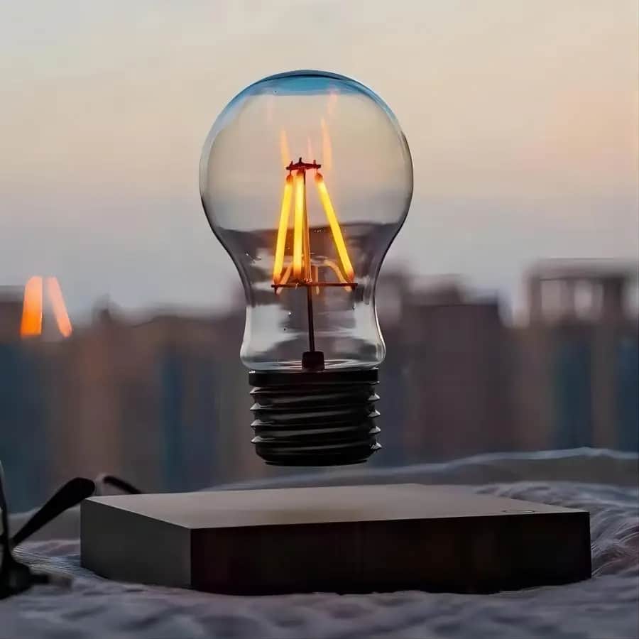 Magnetic levitating LED lamp floating above a natural wood element