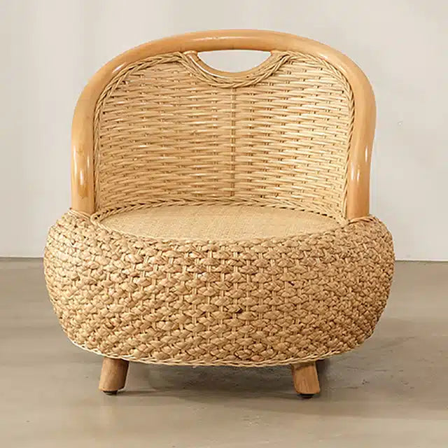 Mini low rattan armchair with rounded arms in natural beige