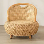 Mini low rattan armchair with rounded arms in natural beige