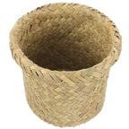 Mini round sand colored rattan wastebasket with a tight weave