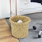 Mini round sand colored rattan wastebasket with a tight weave