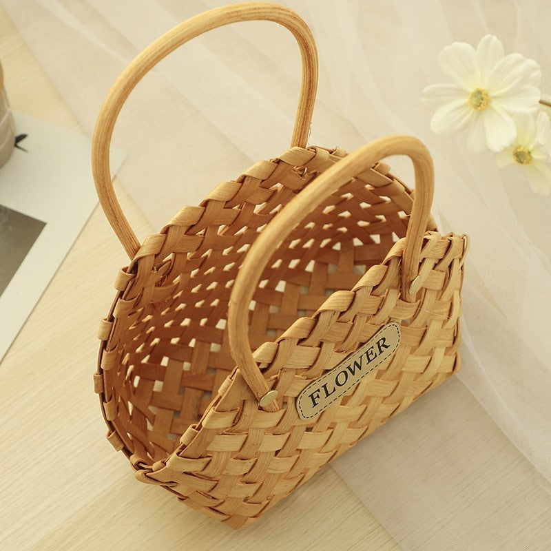 Three mini woven flower baskets with handles and flowers