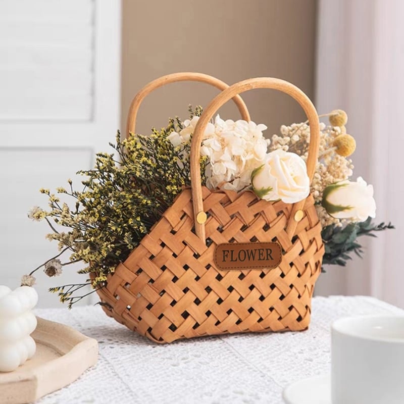 Three mini woven flower baskets with handles and flowers