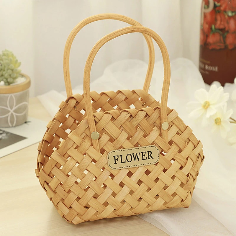 Three mini woven flower baskets with handles and flowers