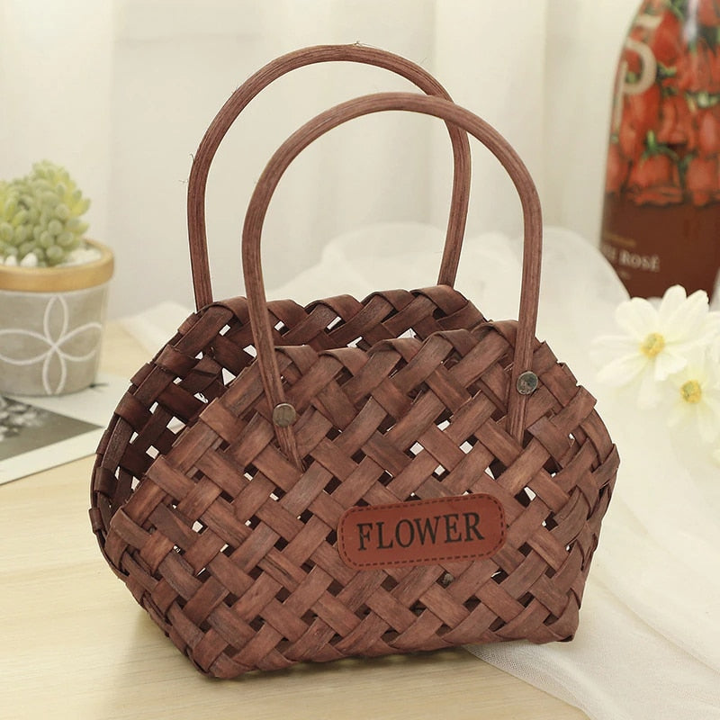 Three mini woven flower baskets with handles and flowers