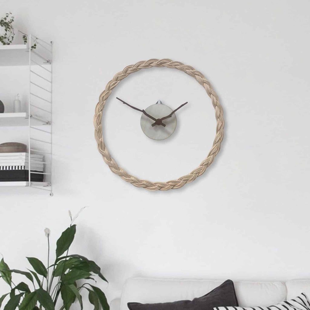 Minimalist wall clock with a braided rattan ring and branch hands