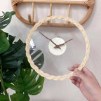 Minimalist wall clock with a braided rattan ring and branch hands