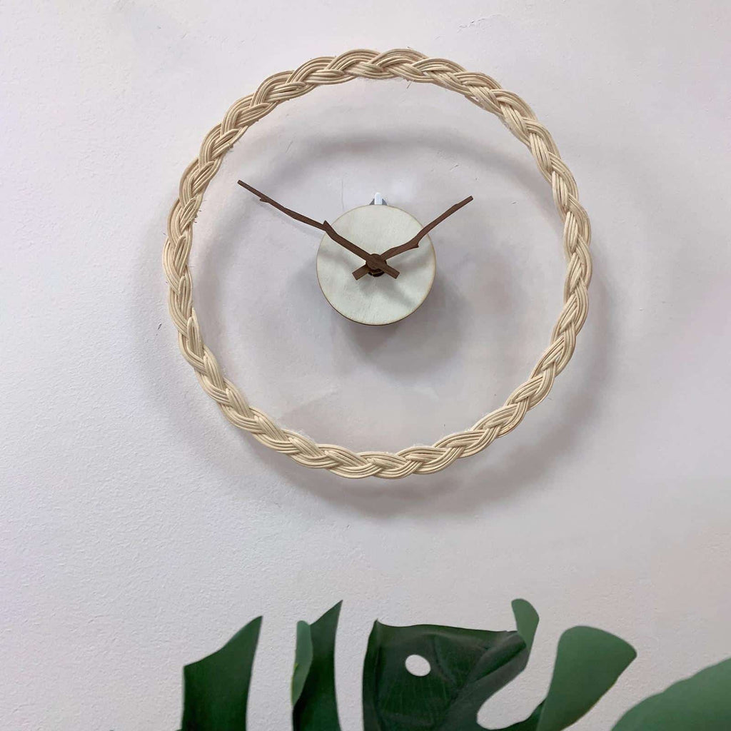 Minimalist wall clock with a braided rattan ring and branch hands