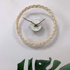 Minimalist wall clock with a braided rattan ring and branch hands