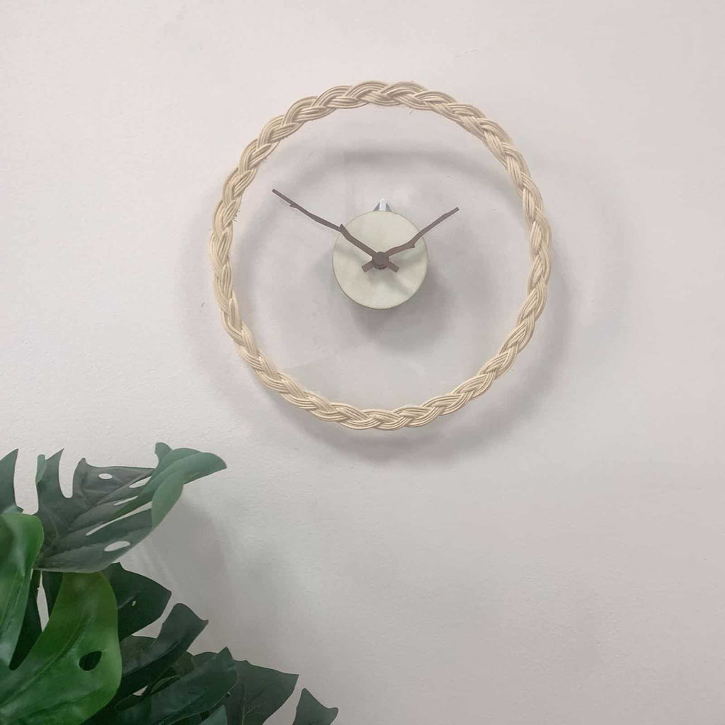 Minimalist wall clock with a braided rattan ring and branch hands