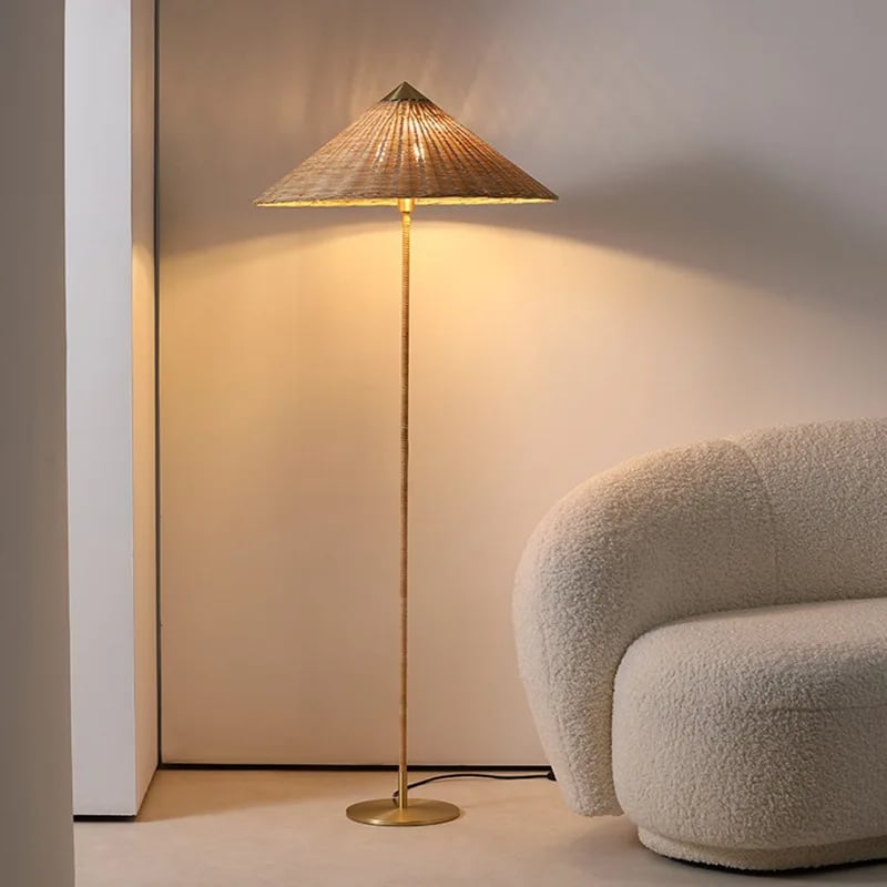 Tall minimalist floor lamp with a woven brown bamboo shade on an iron stand