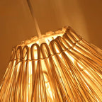 Modern hat shaped pendant light hand woven in beige rattan on an iron frame