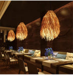 Modern hat shaped pendant light hand woven in beige rattan on an iron frame