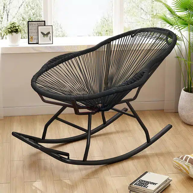 Modern rocking chair hand woven in black rattan with generous curves
