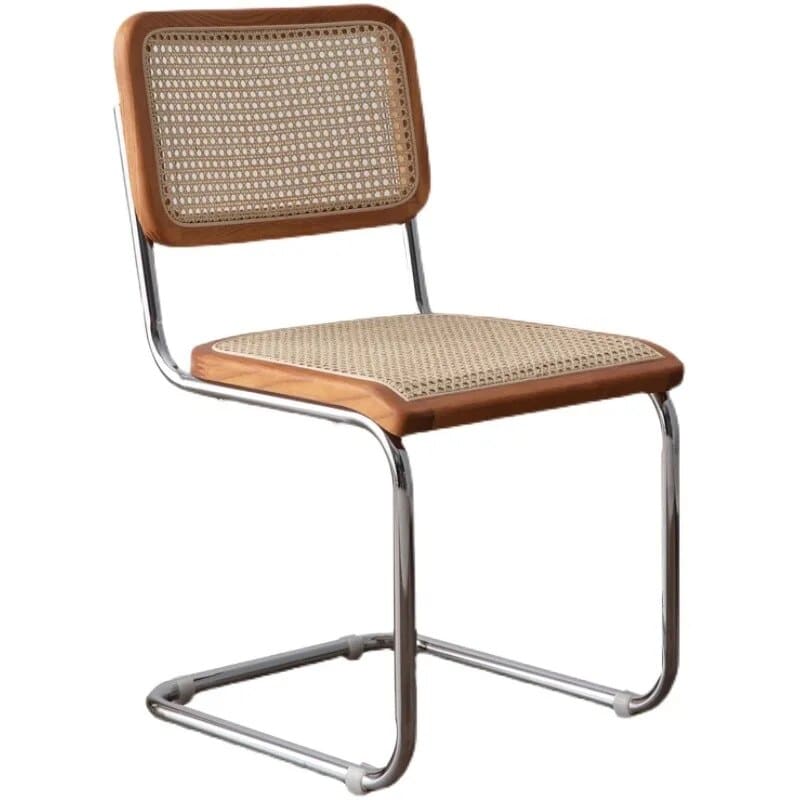 Modern chair with a high, tightly woven rattan back on a stainless steel frame
