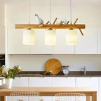 Modern geometric chandelier in brown wood and resin with cut out shapes