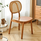 Modern chair with a hand woven rattan seat and back on a brown solid wood frame