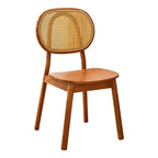 Modern chair with a hand woven rattan seat and back on a brown solid wood frame
