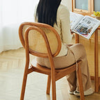 Modern chair with a hand woven rattan seat and back on a brown solid wood frame