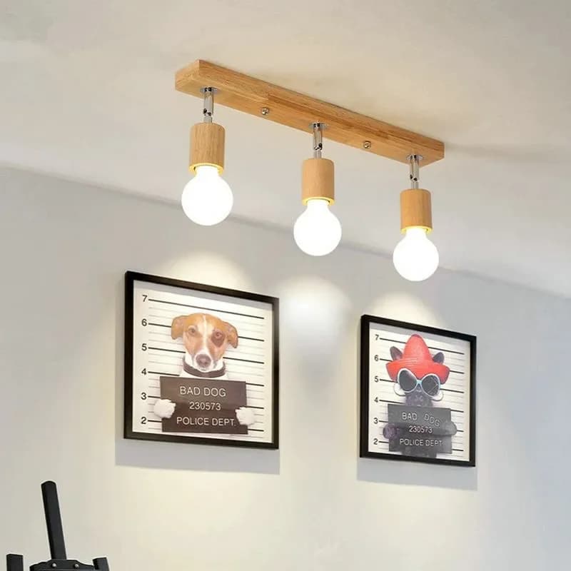 Modern ceiling light with three adjustable heads on a natural wood base