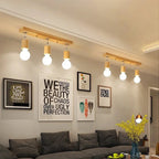 Modern ceiling light with three adjustable heads on a natural wood base