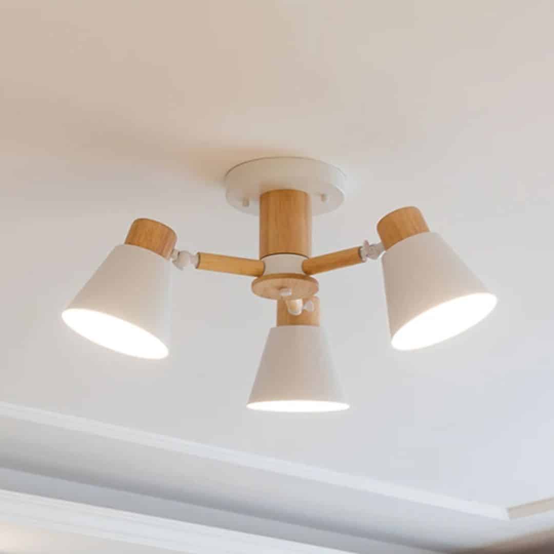 Modern three light chandelier with natural wood shades and a slim metal frame