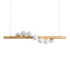 Long modern pendant with a natural wood frame and glass globes