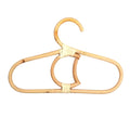 Kids' clothes hanger hand woven in natural rattan in a moon shape