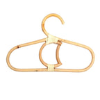 Kids' clothes hanger hand woven in natural rattan in a moon shape