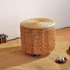 Round natural hand woven footstool on casters with a woven lid