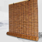 Roll up blind made of round natural stems tied with cord, rolled at the bottom