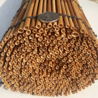 Roll up blind made of round natural stems tied with cord, rolled at the bottom