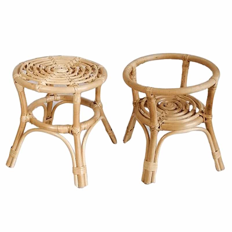 Hand woven natural rattan plant stand holding a potted plant