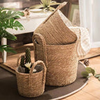 Natural woven storage baskets with handles and plants