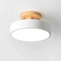 Small Nordic round ceiling light with a natural wood ring and white diffuser