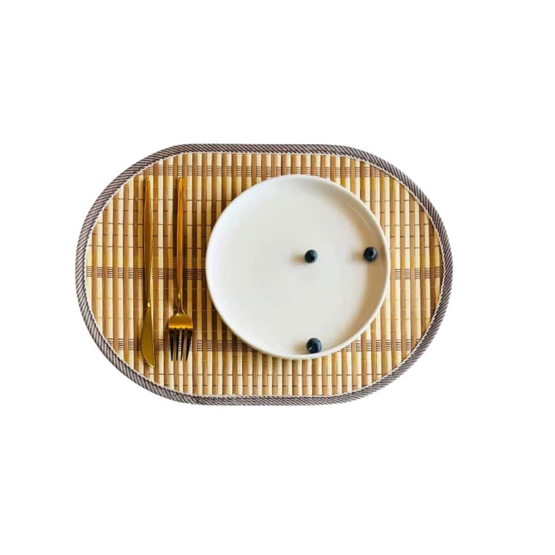 Oval hand woven natural bamboo placemat with even ribs in a Nordic style