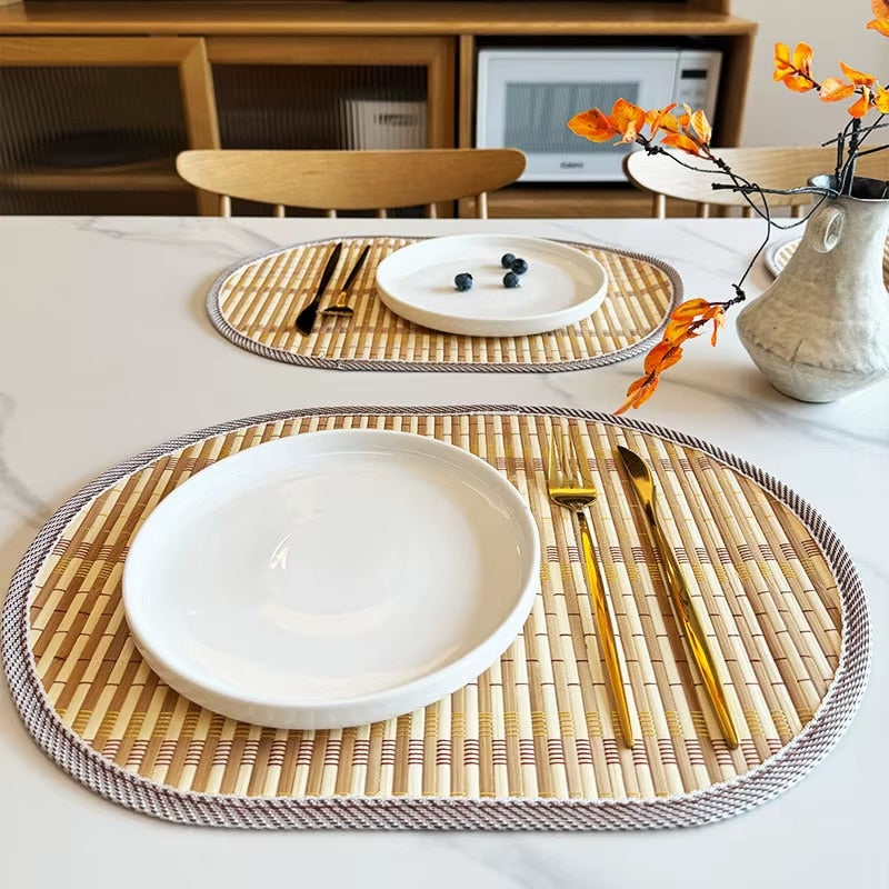 Oval hand woven natural bamboo placemat with even ribs in a Nordic style