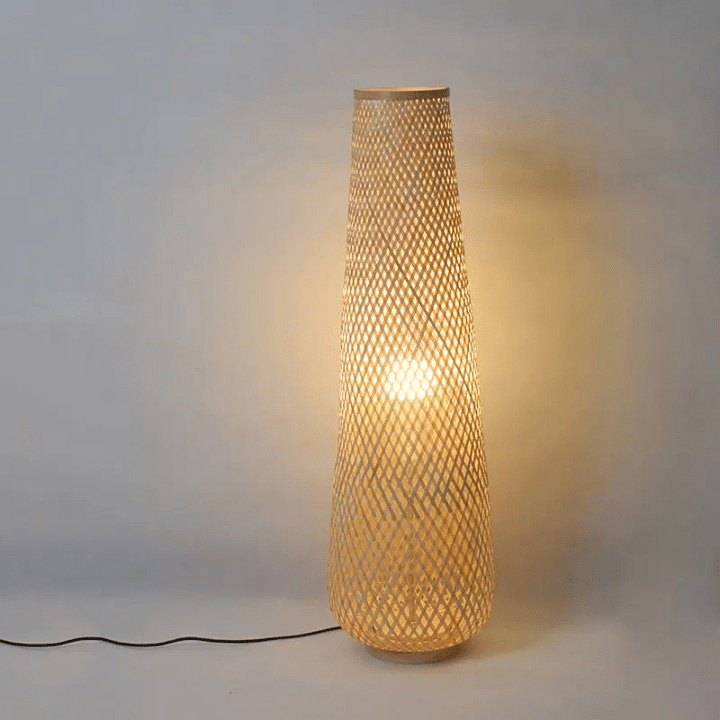 Nordic standing lamp with a hand woven bamboo shade on a slim wood base