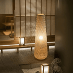 Nordic standing lamp with a hand woven bamboo shade on a slim wood base