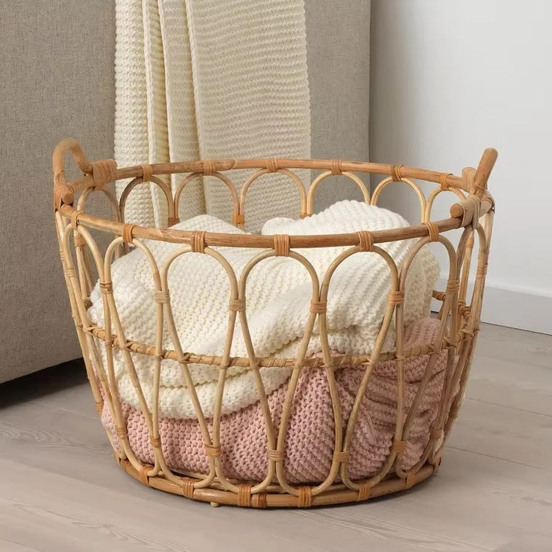 Open frame rattan basket holding folded blankets