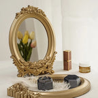 Small oval mirror with ornate gold rose frame