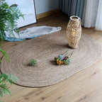 Small oval braided jute rug on a wood floor