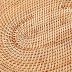 Oval hand woven honey toned natural rattan placemat