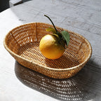 Oval rattan look bread basket with an orange