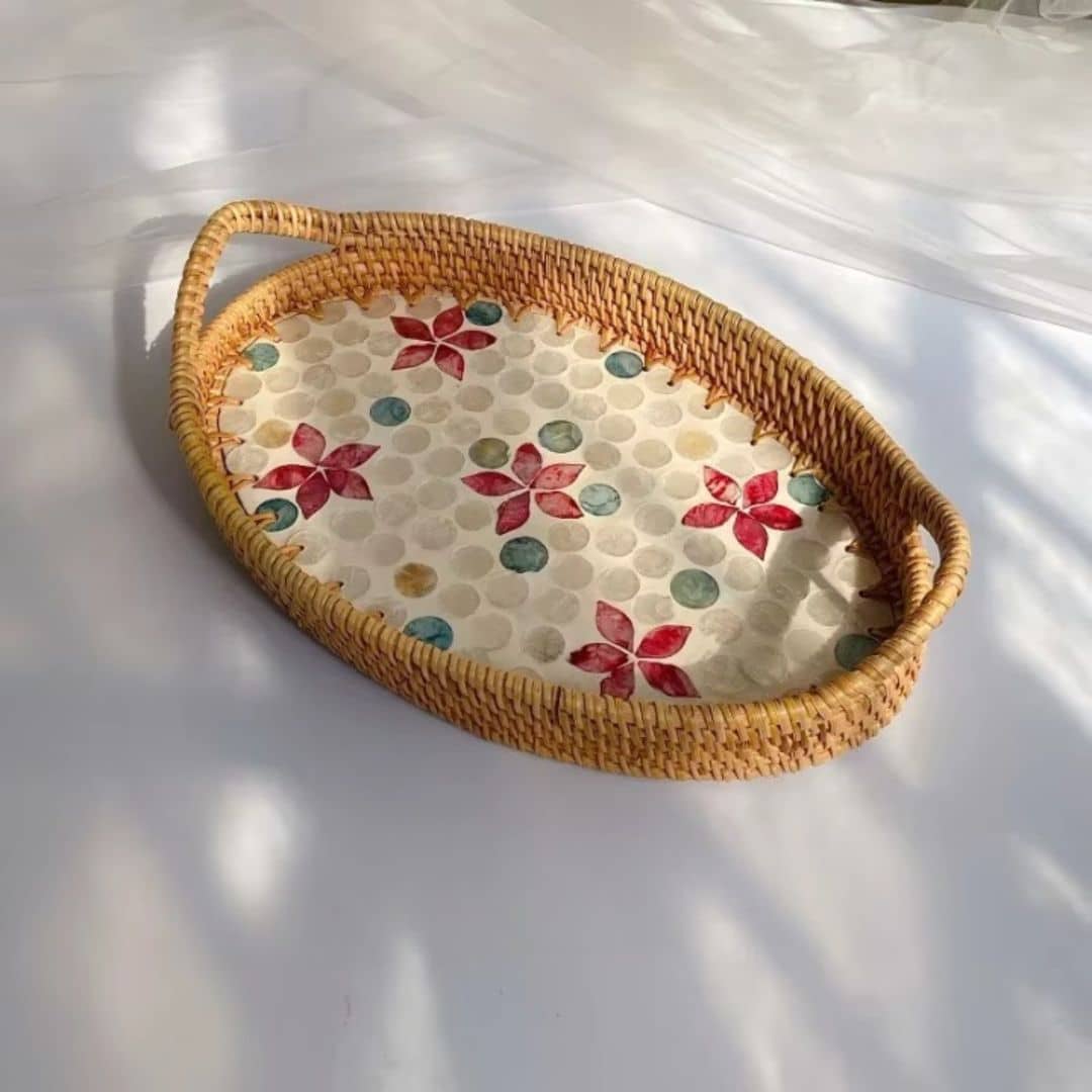 Oval rattan tray with red floral pattern and woven border